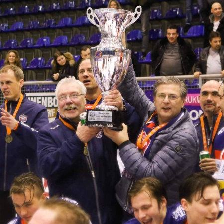 Henny van Gennip en Harry Roelofs tonen de beker.